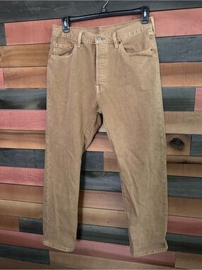 vintage Levi's 501 brown denim jeans featuring a classic button fly